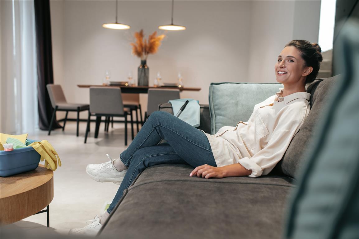 Smiling woman sitting on sofa